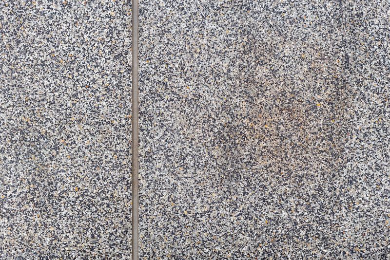 Close-up of an exposed aggregate driveway showing natural stone texture